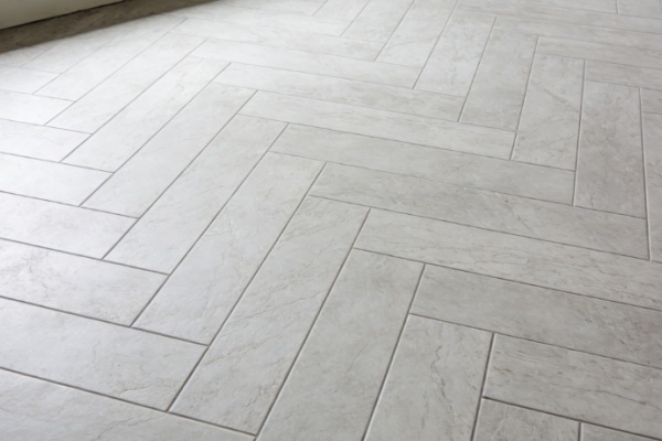 Porcelain Tile Quality Control A factory quality control expert inspecting a large porcelain tile.