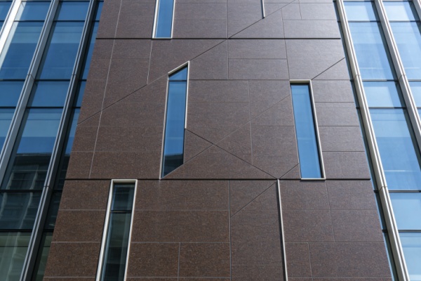 Rainwater washing dirt off an exterior wall clad in flexible stone