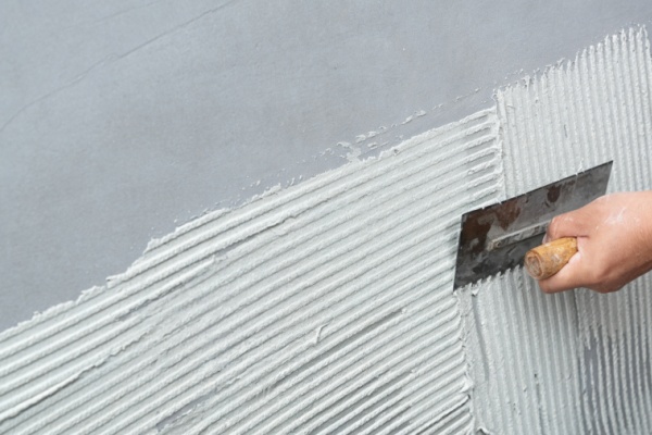 A clean and prepped tile wall ready for flexible stone installation.