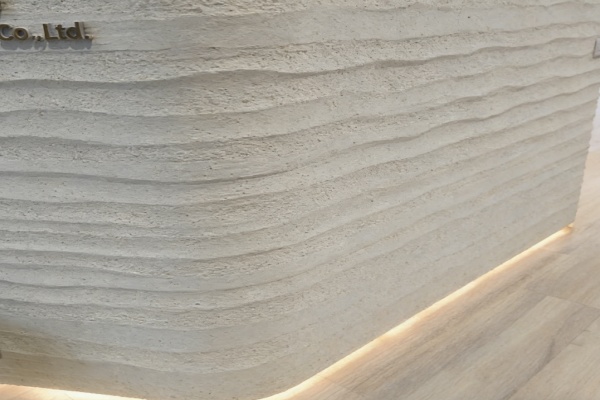 A sample of flexible stone being bent to show its flexibility.