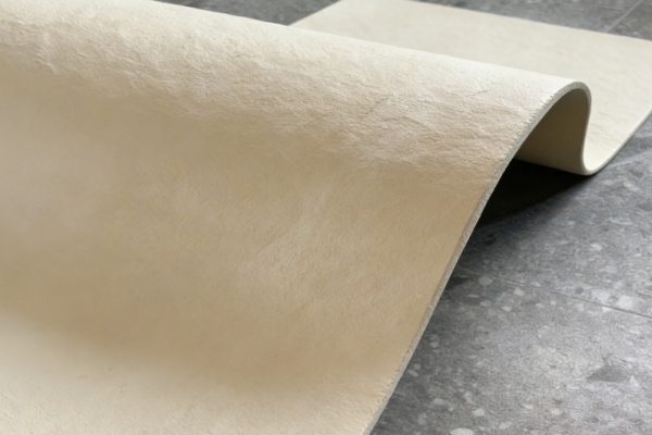 A modern building facade using realistic light-gray faux stone panels