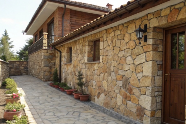 Workers installing heavy natural stone panels on a building facade