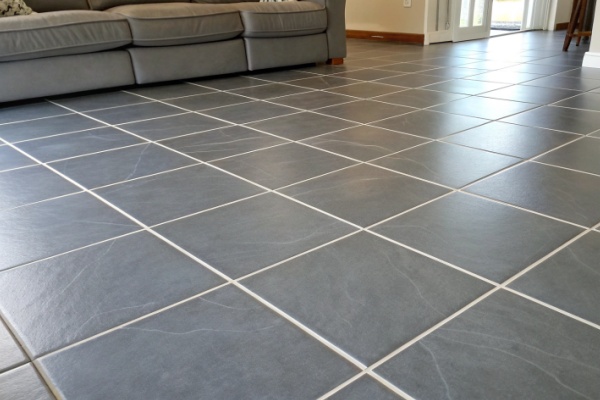 Applying grout into the gaps between tiles