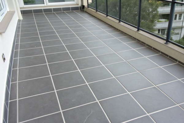 A color chart of different grout options next to a porcelain tile