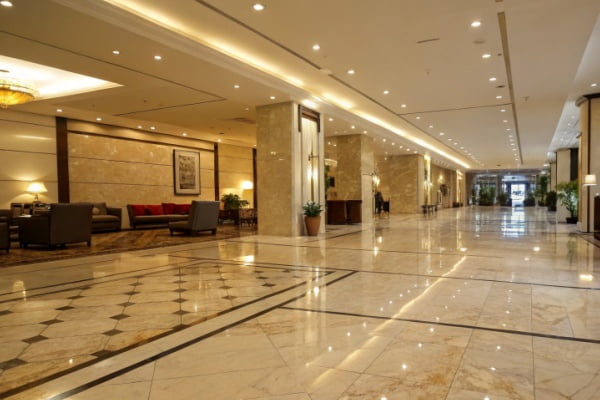Large format marble-look porcelain tiles in a hotel lobby